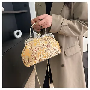 Detailed view of vintage brocade handbag with dragon embroidery and jewel clasp
