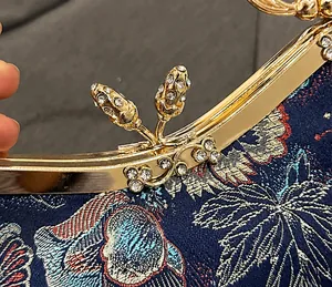 Detail showing the vintage shell bag golden metal clasp with sparkling rhinestones