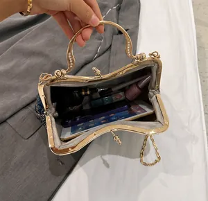 Internal capacity of the vintage blue embroidered shell bag showing phone and cosmetics