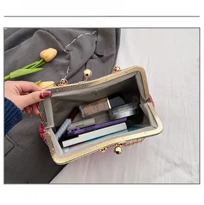 Internal view of red floral embroidery bag showing storage space for makeup and phone