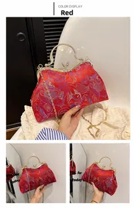 Detail of red Chinese style embroidery handbag with floral patterns and butterfly clasp