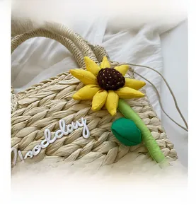 Detailed close-up of straw woven bag texture with sunflower decor and Good Day embroidery