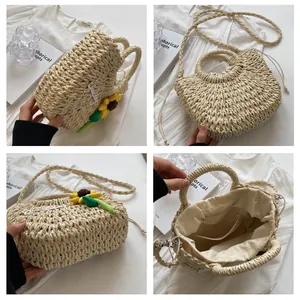 Detail view of woven straw bag with sunflower embroidery and secure drawstring lining