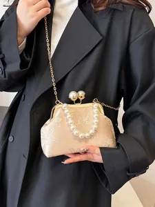 Bolso bordado de satén champán con asa de perlas y motivos de flores y mariposas