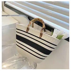 Detail of black and white striped woven tote with bamboo handle and cotton rope texture