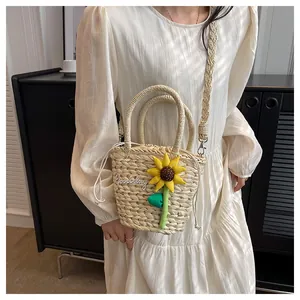 Detail of hand-woven straw bag with 3D sunflower decor and Goodday embroidery
