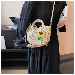 Detail of hand-woven straw bag featuring sunflower decor and Goodday embroidery