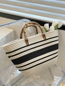 French straw woven tote with black and white stripes and vintage bamboo handles