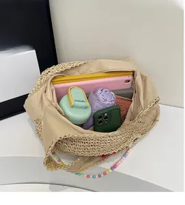 Macro detail of spacious straw bag interior with colorful bead handle and fabric lining