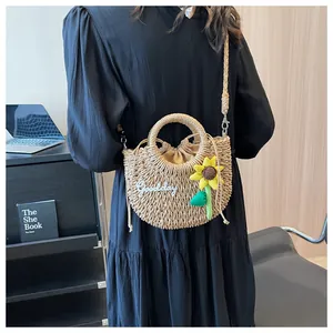 Detail of woven straw bag with sunflower pendant and Goodday patch decoration