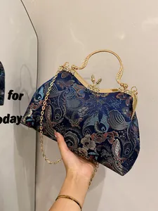 Navy blue chinoiserie shell evening bag with gold floral embroidery and crystal handle