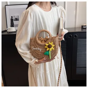 Detailed macro shot of straw woven bag with sunflower decoration and Goodday embroidery