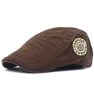 Detail view of cotton flat cap featuring fashion letter embroidery and metal button