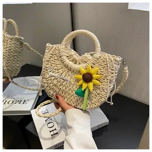 Detail of woven straw bag featuring sunflower decor and Goodday embroidery with drawstring