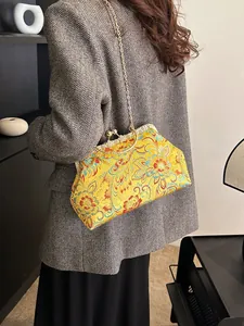 Vintage Chinese embroidered silk handbag with yellow floral patterns and gold chain