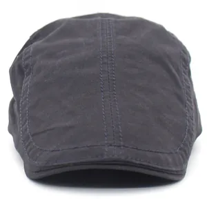 Detailed stitching and texture of navy cotton flat cap with a reinforced brim