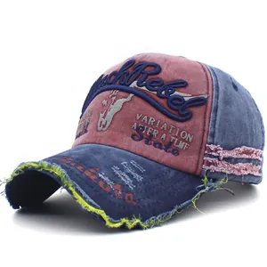 Detail of distressed baseball cap with Rock Rebel embroidery and frayed edges