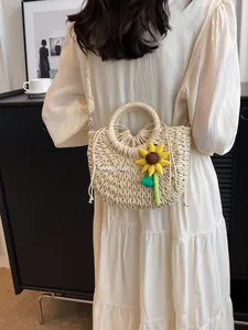 Handwoven straw bag with sunflower detail and Goodday embroidery for summer beach vacation