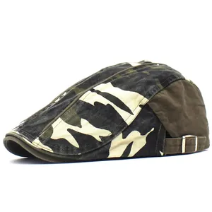 Detail of adjustable metal buckle and woodland camouflage pattern on cotton beret cap