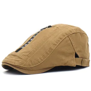 Detail of khaki cotton beret showing top decorative zipper and Follow & Me lettered webbing