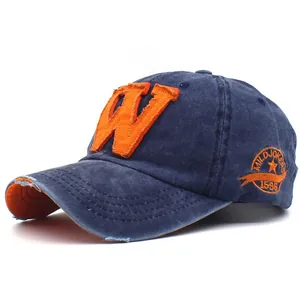 Dettaglio del berretto vintage in cotone lavato blu con patch W arancione e ricamo laterale
