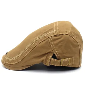 Side view of khaki canvas beret cap featuring metallic buckle and contrast stitching