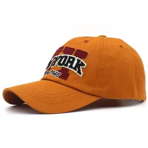 Close-up of ginger cotton baseball cap with New York embroidery and reinforced stitching