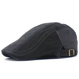 Detail view of cotton flat cap featuring diamond quilting and bronze metal adjustment buckle