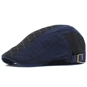 Detail of adjustable metal buckle and plaid stitching on cotton newsboy cap side view