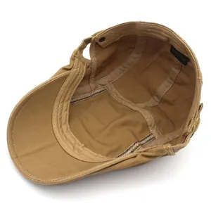 Classic tan cotton newsboy cap showing interior lining, sweatband, and 100% cotton label