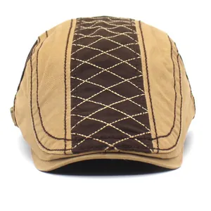 Classic cotton flat cap featuring brown and khaki patchwork with diamond quilt stitching