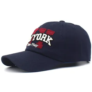 Detail of New York patch embroidery on dark blue cotton baseball cap with ventilation holes