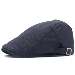 Detailed side view of navy blue beret cap with adjustable silver metal buckle and mesh fabric