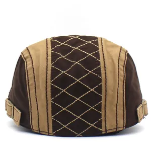 Classic quilted cotton newsboy cap featuring two-tone patchwork and metal side buckles