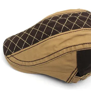 Detail of a color-block cotton newsboy cap with quilted pattern and metal buckle