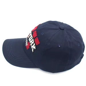 Navy blue cotton baseball cap with white York embroidery and red patch on the side