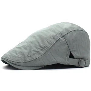 Detail view of the adjustable metal buckle and breathable stitching on the grey flat cap