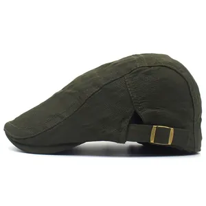 Detail of olive green flat cap showing breathable textured fabric and metal side buckle
