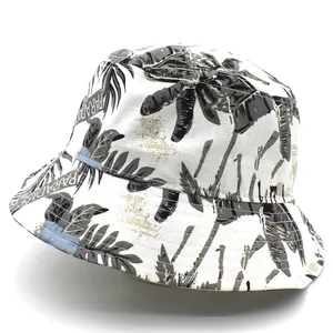 Detailed close-up of tropical palm leaf pattern and Paradise text on canvas bucket hat