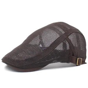 Detail of dark brown mesh beret showing breathable fabric texture and metal buckle