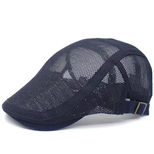 Detail of navy mesh beret cap showing breathable texture and adjustable bronze buckle