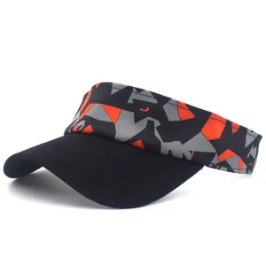 Detail of sports sun visor with geometric orange and grey camouflage pattern on white background