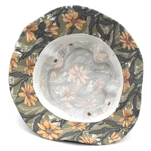 Floral bucket hat with orange daisy prints showing cotton lining and interior label