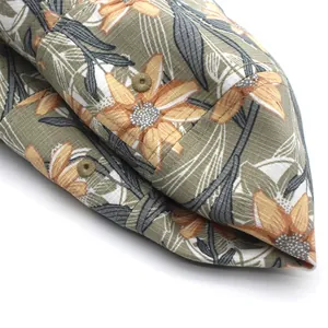 Detailed macro view of olive green floral canvas bucket hat with embroidered eyelets