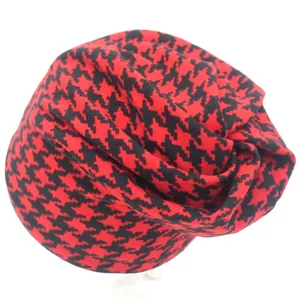Soft red and black houndstooth beanie hat for women featuring a minimalist knitted design