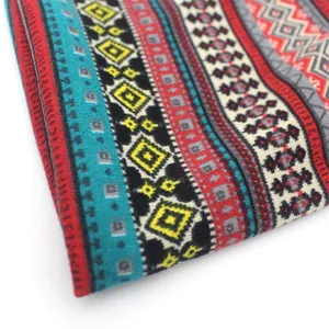 Macro detail of Bohemian knit fabric with geometric patterns in blue, red and yellow