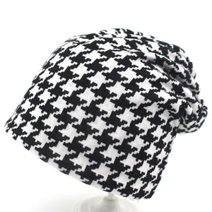 Classic black and white houndstooth knit slouchy beanie for women on a white background