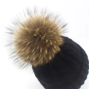 Winter knit beanie with a real raccoon fur pom-pom and thick cable knit texture