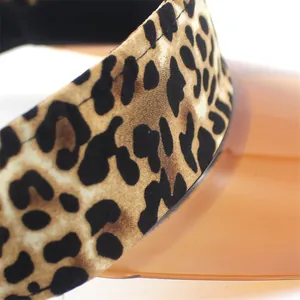 Detail of leopard print fabric and translucent PVC sun visor with premium stitching