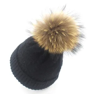 Women's black cable knit beanie with real raccoon fur pom pom for winter warmth